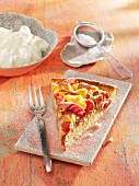 A slice of rhubarb and coconut tart with cream