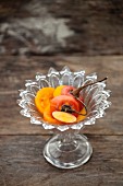 Sliced Japanese persimmon in a crystal dish