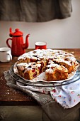 Rustic cherry cake dusted with icing sugar