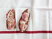 Two slices of bread topped with ham (view from above)