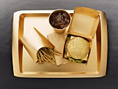 Fast food with a gold-coloured disposable food set