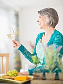 Woman holding a glass of white wine