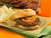 Carrot and mushroom burger in a bun with potato chips