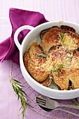 Aubergines topped with cheese and baked, with an almond crust
