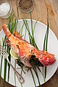 Red mullet stuffed with herbs, on a bed of chives