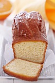 Orange cake, cooked in a loaf tin, partly sliced