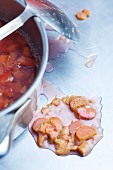 Stewed rhubarb in a saucepan and to one side