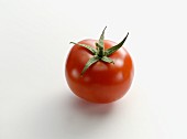 A tomato on a white surface