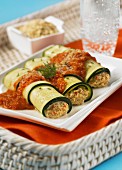 Stuffed, rolled courgette slices with tomato sauce