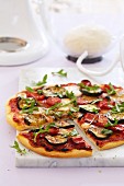 Vegetable pizza topped with peppers, courgette and rocket