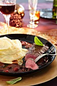 Venison steak with crepes and cranberry sauce for Christmas