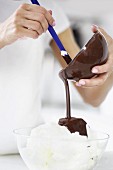 Woman pouring melted chocolate