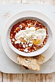 Bean stew with fried eggs and feta