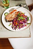 Salmon steak and a cabbage and coleslaw salad
