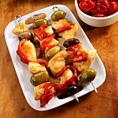 Chicken, Pepper and Olive Skewers on a White Platter