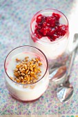 Natural yoghurt with raspberry jam and wheat sprouts in glasses