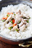 Chicken fricassee with rice in a copper bowl