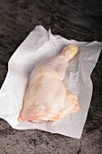 Chicken leg on baking parchment