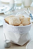 Bread bag decorated with lace trim on breakfast table set in white