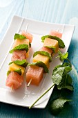 Melon skewers with mint leaves