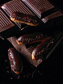 Chocolate éclairs on a stack of cooking chocolate