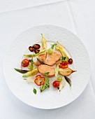 Salmon in a salt crust, sliced and served with grilled vegetables