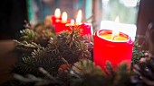 Advent arrangement with lit candles