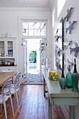 Traditional kitchen with dining area and view of terrace through open garden door