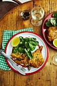 Breaded veal chops with rosemary potatoes and rocket