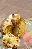 An apple wrapped in pastry with vanilla cream and caramel sauce