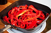 Sliced red peppers in a pan