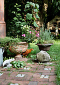 Idyllic garden corner with planters and chicken