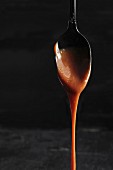 Caramel dripping from a spoon