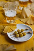 Gingko nuts on skewers and a glass of beer
