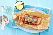 Salmon trout wrapped in prosciutto baked in parchment