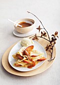 Gingerbread crepes with baked apple wedges and caramel sauce