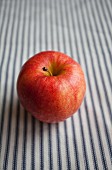 An apple on a striped surface