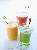 Three differently coloured tomato smoothies