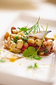 Bean salad with onions, parsley, fennel and cherry tomatoes