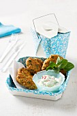 Fritters with chickpeas and sausage served with cucumber yoghurt