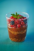 A layered dessert with Spekulatius (German Christmas shortcrust biscuits), chocolate mousse and berries