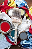 Still-life of paintbrushes, paint pots, fabrics & ribbons