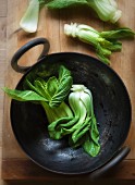 Baby Bok Choy in a Wok and on a Cutting Board
