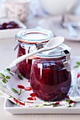 Two jars of red cherry jelly