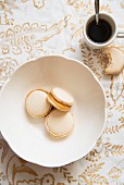 Macaroons with caramel filling, and a cup of coffee