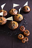 Pumpkin muffins with pumpkins seeds and small flags