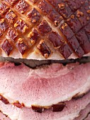 Roast crackling pork, partly sliced (close-up)