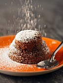 Mi-cuit de chocolat (mini chocolate cake, France) dusted with icing sugar
