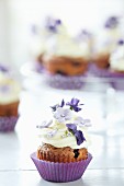 Blueberry cupcake with sugar flowers and violets