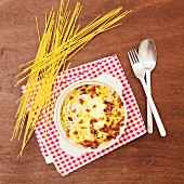 Spaghetti with sweetcorn, topped with cheese sauce and baked